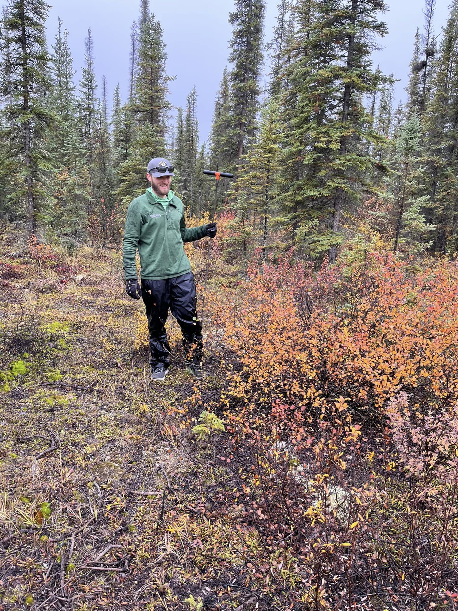 A researcher taking active layer depth measurements